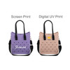 A purple tote bag with holes and black handles, next to a pink tote bag with holes and black handles, both featuring logos.
