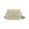 A beige EVA briefcase with perforated holes, featuring a detachable shoulder strap and a clasp closure.
