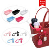 A red EVA Holes beach bag with various inserts and heart-shaped accessories in pink, black, white, and blue.
