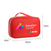 A red first aid kit bag with a handle, featuring a logo and dimensions of 22cm x 13cm x 6cm.