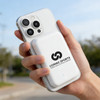 A white magnetic wireless power bank is attached to a phone, held in a hand, with a logo displayed on the power bank.