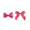 Two pink adhesive bows displayed side by side, with text printed on them. One is smaller, the other larger.