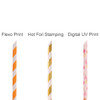 A selection of four custom disposable 4-ply paper straws in orange and white, gold, and a pink floral design.