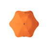 An orange BLUNT Metro Umbrella with a unique octagonal shape and central button for opening and closing.