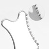 A silver Gua Sha tool with rounded edges and small beads along one side, featuring a close-up detail of the beads.