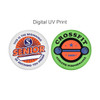 Two circular promotional pins featuring vibrant designs, one in orange and blue, the other in green and black. Each pin has a logo.