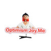 A custom felt hair clip featuring a character with red hair and the phrase "Optimism Joy Me" in bold text.