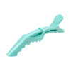 A turquoise alligator clip with an anti-slip grip feature and a textured top for secure holding.