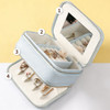 A light blue PU leather jewellery case with a mirror, including compartments for rings and earrings.