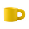 A yellow ceramic coffee mug with a distinctive handle, featuring a smooth matte finish and no patterns or designs.