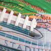 A colourful promotional American football featuring white laces and a detailed design of a stadium.