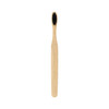 A large flat handle toothbrush with a natural bamboo handle and black bristles. Features a simplistic design.