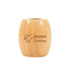 A bamboo toothbrush stand in a light wood colour with a logo on the front.