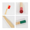 A colorful bamboo toothbrush with a red and green round handle, showcasing various angles and bristle details.