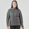 A grey women's softshell jacket with a quilted front and a zip-up design, featuring a logo on the chest.