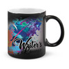 A coffee mug featuring a colourful splash design with a black exterior and white interior. It has a branding logo.