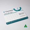 A mouse mat featuring a calendar for January 2025, in blue and green tones, with a logo and Australian-made badge.