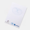 A5 notepad featuring white pages with a subtle blue design and branding logos at the bottom.