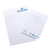 A notepad featuring lined pages, with a logo on the top and a smaller pad beside it, on a wooden surface.