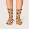 Bright orange socks with repeated Fanta branding, featuring a logo and green leaf design.