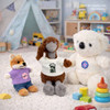 A plush doll wearing a white T-shirt, alongside a koala and a fox in colourful outfits, with toys in the background.