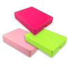 Three plastic mirror boxes in pink, light pink, and bright green stacked together.