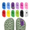 Clog shoe shaped charms in various colours, including pink, blue, green, black, and a purple charm with a logo.