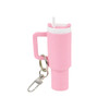 A pink mini tumbler keyring with a straw and a metal clip for attachment. Features a handle for easy gripping.