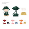 A plush doll apron outfit featuring green clothing items, a hat, and colourful shorts in yellow, pink, orange, and red.