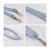 A drink bottle strap featuring a light blue silicone design with metal clips and textured grip.