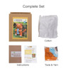 A crochet kit in a cardboard box featuring orange yarn, cotton, tools, and instructions for making toys.