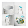 A white ceramic mug featuring a rugby-themed design and a blue custom spinner toy attached to the handle.