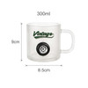 A frosted glass mug featuring a tyre design and a logo, with dimensions of 300ml capacity.