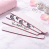 A set of half moon shaped nail files featuring a butterfly design and a personalised name, with a pink trim.