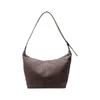 A grey canvas tote bag with a single shoulder strap and a zip closure, featuring a logo on the front.