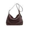 A brown polyurethane tote bag with a slouchy design and a single shoulder strap. It features a logo.