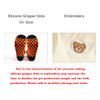 A pair of sport socks featuring silicone gripper dots on the sole and an embroidered bear design.