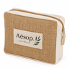 A jute cosmetic bag with a beige canvas front and a zipped closure, featuring a logo.