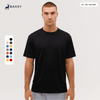 A man wearing a black t-shirt, featuring short sleeves and a relaxed fit, displayed with a colour palette alongside.