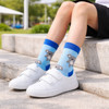 Woven socks featuring a blue koala design on a light blue background, paired with white sneakers.