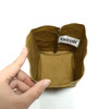 A small brown kraft paper storage bag with a decorative tag inside, being held by a hand.