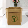 A large brown kraft paper storage bag featuring a green logo of a tree and leaves, placed on a table.