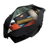 A black duffel bag open to reveal neatly packed items, including clothing and accessories in various colours.