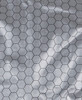 A close-up of a light grey fabric featuring a hexagonal pattern, typical of graphene puffer jackets.