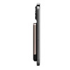 A thin, rectangular magnetic wireless power bank in black and gold, positioned beside a smartphone to show thickness.