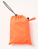 An orange waterproof bag with a drawstring closure, suitable for storing lightweight nylon rain pants.