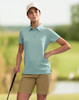 A teal ladies' sustainable jacquard knit short sleeve polo with a collar and side split. It has a logo on it.