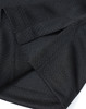 A close-up of a black sustainable jacquard knit polo featuring textured fabric and detailed stitching.