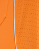 Close-up of an orange polo shirt featuring a textured pattern and a reflective trim. The shirt has a logo.
