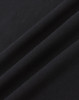 A close-up of black cotton fabric with a smooth texture, featuring subtle folds.